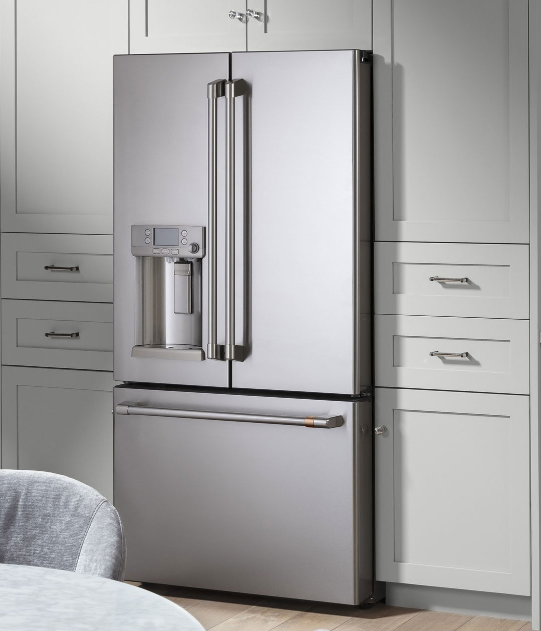 stainless steel refrigerator with grey cabinets